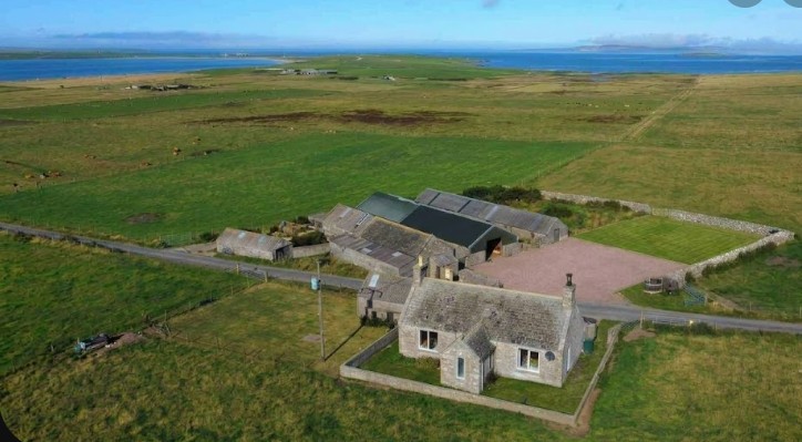Aerial view of Smiddy Smallholding — stone croft, outbuildings and 32 acres on the Stronsay coast